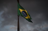 A Brazilian flag flutters outside the Supreme Court building in Brasilia on January 10, 2023, two days after thousands of supporters of Brazil's far-right ex-president Jair Bolsonaro raided federal buildings. - President Luiz Inacio Lula da Silva condemned "acts of terrorism" after a far-right mob stormed the seat of power, unleashing chaos on the capital. (Photo by CARL DE SOUZA / AFP) (Photo by CARL DE SOUZA/AFP via Getty Images)