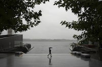 A pedestrian walks with an umbrella along the empty waterfront as heavy rain falls in Halifax on Thursday, September 14, 2023. Residents in Nova Scotia and New Brunswick are being told to prepare for strong winds and more heavy rain this weekend as Hurricane Lee is expected to make landfall as a post-tropical storm.

Darren Calabrese/The Globe and Mail