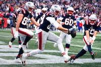 New England Patriots tight end Mike Gesicki, center, celebrates with teammates after his touchdown against the Buffalo Bills during the second half of an NFL football game, Sunday, Oct. 22, 2023, in Foxborough, Mass. (AP Photo/Michael Dwyer)