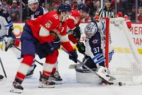 Nov 24, 2023; Sunrise, Florida, USA; Winnipeg Jets goaltender Connor Hellebuyck (37) defends his net from Florida Panthers left wing Matthew Tkachuk (19) during the second period at Amerant Bank Arena. Mandatory Credit: Sam Navarro-USA TODAY Sports