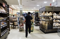In new court filings, Metro Inc. is accusing Loblaw Cos. Ltd. and its parent company of conspiring to implicate Metro in an alleged bread price-fixing conspiracy. A worker walks around a Metro grocery store in Toronto, Tuesday, July 18, 2023. THE CANADIAN PRESS/Cole Burston