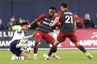 Simcoe County Rovers' Alejandro Portal, left, battles for the ball with Toronto FC's Cassius Mailula and Jonathan Osorio during first half Canadian Championship soccer action, in Toronto, Wednesday, April 24, 2024. THE CANADIAN PRESS/Chris Young