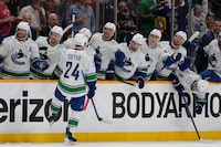 Vancouver Canucks center Pius Suter (24) celebrates his goal against the Nashville Predators with teammates during the third period in Game 6 of an NHL hockey Stanley Cup first-round playoff series Friday, May 3, 2024, in Nashville, Tenn. The Canucks won 1- 0. (AP Photo/George Walker IV)