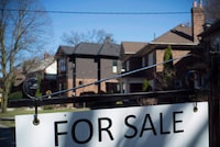 A for sale sign is shown in front of west-end Toronto homes Sunday, April 9, 2017.