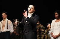 NEW YORK, NEW YORK - JANUARY 26: John Riddle (L) as "Raoul", Emilie Kouatchou (R) as "Christine", look on as Ben Crawford (C), as "The Phantom", makes a speech after the curtain call at the 35th anniversary performance of Andrew Lloyd Webber's "The Phantom of the Opera" on Broadway at the Majestic Theatre on January 26, 2023 in New York City. (Photo by Dia Dipasupil/Getty Images)