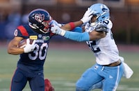 Montreal Alouettes wide receiver Chandler Worthy (30) is called for face masking against Toronto Argonauts defensive back Qwan'tez Stiggers (42) during first half CFL football action in Montreal, Friday July 14, 2023.  THE CANADIAN PRESS/Christinne Muschi