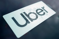 FILE - An Uber sign is displayed inside a car in Palatine, Ill., Feb. 10, 2022. A failed Australian taxi industry disruptor has on Tuesday, April 2, 2024, begun its law suit against Uber claiming the U.S. giant began illegally operating ride sharing in Australia to gain an unfair advantage over competitors. (AP Photo/Nam Y. Huh, File)