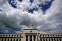 FILE PHOTO: Flags fly over the Federal Reserve building on a windy day in Washington, U.S., May 26, 2017. REUTERS/Kevin Lamarque/File photo