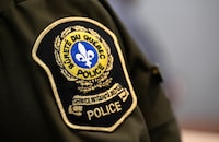 The suspect in a hit-and-run that killed a 30-year-old man in the Montreal area on Thursday has turned himself in to police. The Quebec provincial police patch is seen at a news conference in Quebec City on Feb. 29, 2024. THE CANADIAN PRESS/Jacques Boissinot