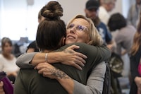 Carrie Low, right, hugs a supporter during a break in her testimony at a Police Review Board hearing in Halifax on Monday, July 10, 2023. Low alleges the Halifax Regional Police and Const. Bojan Novakovic, the first officer to interview her, mishandled her 2018 sexual assault case after she reported being forcibly confined and raped by at least two men in a trailer in East Preston, N.S. THE CANADIAN PRESS/Darren Calabrese