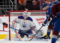 Edmonton Oilers goaltender Calvin Pickard, left, stops a shot by Colorado Avalanche right wing Valeri Nichushkin during the second period of an NHL hockey game Thursday, April 18, 2024, in Denver. (AP Photo/David Zalubowski)