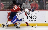 Florida Panthers right wing William Lockwood works for the puck against Montreal Canadiens defenseman Kaiden Guhle during the second period of an NHL hockey game Saturday, Dec. 30, 2023, in Sunrise, Fla. (AP Photo/Michael Laughlin)