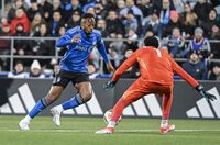 CF Montreal's Mason Toye, left, gets by Orlando City goalkeeper Pedro Gallese to score during first half MLS soccer action in Montreal, Saturday, April 20, 2024. THE CANADIAN PRESS/Graham Hughes