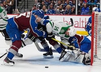 Dallas Stars left wing Jamie Benn (14) tumbles into Colorado Avalanche goaltender Alexandar Georgiev (40) with a push from defenseman Jack Johnson in the second period of Game 4 of an NHL hockey Stanley Cup playoff series Monday, May 13, 2024, in Denver. (AP Photo/David Zalubowski)