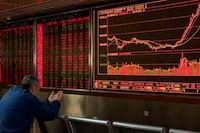 In this Jan. 16, 2020, file photo, an investor monitors stock prices at a brokerage in Beijing.