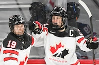 Marie-Philip Poulin (29) of Canada celebrates with teammate Brianne Jenner (19) after scoring against the USA during second period Rivalry Series hockey action in Laval, Que., Wednesday, February 22, 2023. Poulin will lead an experienced squad when Canada seeks its third straight women's world hockey title next month. THE CANADIAN PRESS/Graham Hughes