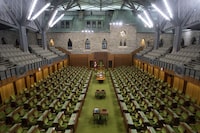 The House of Commons chamber is seen empty, Wednesday, April 8, 2020 in Ottawa. When Parliament resumes on Nov. 22, no one will be allowed into the House of Commons precinct unless they are fully vaccinated against COVID-19. THE CANADIAN PRESS/Adrian Wyld