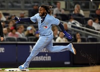 NEW YORK, NEW YORK - APRIL 21:  Vladimir Guerrero Jr. #27 of the Toronto Blue Jays rounds third and scores off a double from teammate Brandon Belt in the eighth inning against the New York Yankees at Yankee Stadium on April 21, 2023 in the Bronx borough of New York City. (Photo by Elsa/Getty Images)