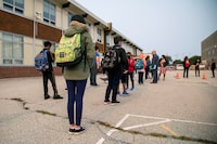Students arrive for the first time since the start of the coronavirus disease (COVID-19) pandemic at Hunter's Glen Junior Public School, part of the Toronto District School Board (TDSB) in Scarborough, Ontario, Canada September 15, 2020. REUTERS/Carlos Osorio