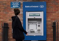 A person passes an out of service ATM at a Bank of Ireland branch in Finglas village, Dublin, Wednesday Aug. 16, 2023. Some Bank of Ireland customers were able to withdraw money they did not have Tuesday and early Wednesday, thanks to an hours-long technical glitch that also halted many of the bank’s online services. The outage allowed some customers to transfer and withdraw funds “above their normal limits,” the Bank of Ireland said. (Brian Lawless/PA via AP)