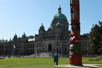 The Knowledge Totem pole carved by Coast Salish artist Cicero August and his sons Darrell and Doug August of the Cowichan Tribes stands tall on the front lawn of the legislature at Victoria, B.C., on Wednesday, May 8, 2024. THE CANADIAN PRESS/Chad Hipolito   