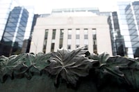 A sign framed by maple leaves is pictured in front of the Bank of Canada building in Ottawa July 17, 2012. The Bank of Canada’s next interest rate announcement is on March 6.