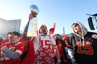 KANSAS CITY, MISSOURI - FEBRUARY 14:  Kansas City Chiefs fan Blair Falconer poses with a replica Lombardi trophy during the Kansas City Chiefs Super Bowl LVIII victory parade on February 14, 2024 in Kansas City, Missouri. (Photo by Jamie Squire/Getty Images)