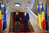 Ukrainian President Volodymyr Zelensky (L) and his Romanian counterpart Klaus Iohannis shake hands at the Cotroceni Palace, the Romanian Presidency headquarters in Bucharest on October 10, 2023. (Photo by Daniel MIHAILESCU / AFP) (Photo by DANIEL MIHAILESCU/AFP via Getty Images)