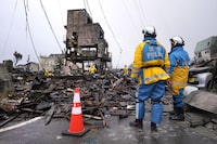 Police officers search victims from debris of damaged and burnt buildings in Wajima in the Noto peninsula facing the Sea of Japan, northwest of Tokyo, Sunday, Jan. 7, 2024. Monday's temblor decimated houses, twisted and scarred roads and scattered boats like toys in the waters, and prompted tsunami warnings. THE CANADIAN PRESS/AP-Hiro Komae