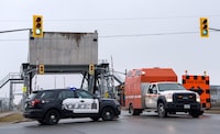 A company running hazardous waste plant in St. Catharines, Ont. and its directors have been charged with 84 fire code offences after a fire in its facility left a worker dead and led to an evacuation of nearby homes. Police block off a bridge following the explosion and fire in St. Catharines, Ont., on Thursday January 12, 2023. THE CANADIAN PRESS/Alex Lupul