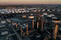 A view of the Phillips 66 Company's Los Angeles Refinery (foreground), which processes domestic & imported crude oil into gasoline, aviation and diesel fuels, and storage tanks for refined petroleum products at the Kinder Morgan Carson Terminal (background), at sunset in Carson, California, U.S., March 11, 2022. Picture taken March 11, 2022. Picture taken with a drone. REUTERS/Bing Guan