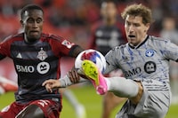 CF Montreal's Matko Miljevic (right) tries cross the ball  past Toronto FC's Richie Laryea during second half Canadian Championship quarterfinal soccer action in Toronto on Tuesday, May 9, 2023.THE CANADIAN PRESS/Chris Young