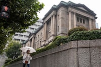 A pedestrian walks past the Bank of Japan (BoJ) complex in central Tokyo on October 4, 2023. (Photo by Richard A. Brooks / AFP) (Photo by RICHARD A. BROOKS/AFP via Getty Images)