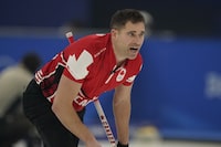 John Morris, of Canada, yells to his teammate after he throws a rock during the mixed doubles curling match against the Czech Republic at the Beijing Winter Olympics on Monday, Feb. 7, 2022, in Beijing. A group that includes two-time Olympic gold medal curler Morris and former NFL player Jared Allen has purchased the Grand Slam of Curling tour from Sportsnet. THE CANADIAN PRESS/AP/Brynn Anderson</p>