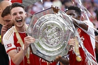 Arsenal's Declan Rice, left, lifts the trophy after winning the English FA Community Shield final soccer match between Arsenal and Manchester City at Wembley Stadium in London, Sunday, Aug. 6, 2023. (AP Photo/David Cliff)