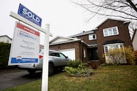 FILE PHOTO: A house with a sold real estate sign on it in a neighbourhood of Ottawa, Ontario, Canada April 17, 2023.  REUTERS/Lars Hagberg/File Photo