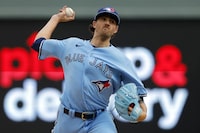 Toronto Blue Jays starting pitcher Kevin Gausman throws to a Minnesota Twins batter during the first inning in Game 1 of an AL wild-card baseball playoff series Tuesday, Oct. 3, 2023, in Minneapolis. (AP Photo/Bruce Kluckhohn)