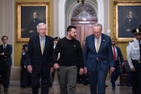 FILE - Ukrainian President Volodymyr Zelenskyy, center, is escorted by Senate Minority Leader Mitch McConnell, R-Ky., left, and Senate Majority Leader Chuck Schumer, D-N.Y., as he comes to the Capitol in Washington, to issue a plea for Congress to break its deadlock and approve continued wartime funding for Ukraine, Dec. 12, 2023. Two months later, that aid request had still not been met but Schumer and McConnell are keeping the Senate in session on Super Bowl weekend to force funding for Ukraine and Israel. (AP Photo/J. Scott Applewhite, File)