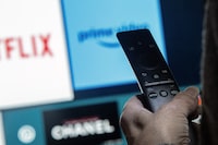 A new report suggests Canadians' television viewing habits continue to shift toward streaming platforms at the expense of traditional cable and satellite subscriptions, at a time when the federal regulator considers new rules to help level the playing field across the sector. A television remote control shows buttons to access streaming services Netflix and Amazon Prime, in a photo illustration made in Toronto, Friday, March 22, 2024. THE CANADIAN PRESS/Giordano Ciampini
