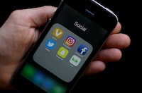 FILE - This June 16, 2017, file photo shows social media app icons on a smartphone held by an Associated Press reporter in San Francisco. The Ivy League university announced Monday, June 17, 2019, that it would revoke an admission offer to a survivor of the Parkland high school massacre because of racist social media posts. The decision serves as a reminder to aspiring college students and all young people that their online comments, even those considered private, can resurface and be used against them. (AP Photo/Jeff Chiu, File)