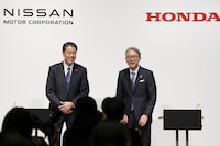 Nissan Chief Executive Makoto Uchida, left, and Honda President Toshihiro Mibe attend a joint news conference in Tokyo, Friday, March 15, 2024. Nissan and Honda announced Friday that they will work together in developing electric vehicles and auto intelligence technology, sectors where Japanese automakers have fallen behind. (Kyodo News via AP)