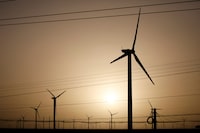 FILE PHOTO: Wind turbines stand on a power station near Yumen, Gansu province, China September 25, 2020. REUTERS/Carlos Garcia Rawlins/File Photo