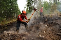 Firefighters with the British Columbia Wildfire Service Titan unit crew work to control the southeastern flank of the Bush Creek wildfire in Turtle Valley, after it destroyed homes and other structures in multiple communities in the North Shuswap region of British Columbia, Canada. August 23, 2023 REUTERS/Jesse Winter