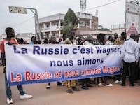 Demonstrators carry banners in Bangui, on March 22, 2023 during a march in support of Russia and China's presence in the Central African Republic. - Central African Republic authorities have opened an investigation into the deaths of nine Chinese nationals killed in an attack on a gold mine in the centre of the country on March 19, 2023. Taking advantage of the vacuum created by the departure of the bulk of French troops, Moscow sent "military instructors" to the country in 2018, then hundreds of Wagner paramilitaries in 2020 at the request of Bangui, faced with a threatening rebellion. (Photo by Barbara DEBOUT / AFP) (Photo by BARBARA DEBOUT/AFP via Getty Images)