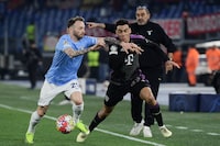 Lazio's Italian midfielder #29 Manuel Lazzari fights for the ball with Bayern Munich's German midfielder #42 Jamal Musiala (R) during the UEFA Champions League last 16 first leg between Lazio and Bayern Munich at the Olympic stadium on February 14, 2024 in Rome. (Photo by Filippo MONTEFORTE / AFP) (Photo by FILIPPO MONTEFORTE/AFP via Getty Images)