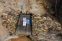 The entrance of a closed goldmine gallery is seen near Rosia Montana, central Romania, March 24, 2014. Romania's lower house rejected a bill on June 3 that would have enabled Canada's Gabriel Resources to set up Europe's biggest open-cast gold mine in the small Carpathian town of Rosia Montana, putting the project on hold indefinitely. The bill, which was initially approved by the leftist government of Prime Minister Victor Ponta, drew thousands of anti-mine protesters into the streets across the European Union state last year, prompting the senate to strike it down. Picture taken March 24, 2014. REUTERS/Bogdan Cristel (ROMANIA - Tags: BUSINESS ENVIRONMENT POLITICS) - GM1EA64042801