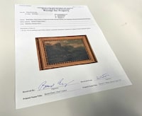 This photo shows a U.S. Department of Justice receipt for property transferring ownership of the 18th century painting titled "Landscape of Italian Character" by Vienna-born artist Johann Franz Nepomuk Lauterer, Thursday, Oct. 19, 2023 in Chicago. After going missing nearly 80 years ago, the "Landscape of Italian Character", a baroque landscape painting was returned to a German museum representative in a brief ceremony at the German Consulate in Chicago, where the pastoral piece of an Italian countryside was on display. (AP Photo/Claire Savage)