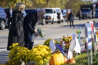 President Joe Biden and first lady Jill Biden lay flowers at Schemengees Bar and Grille, one of the sites of last week's mass shooting, Friday, Nov. 3, 2023, in Lewiston, Maine. (AP Photo/Evan Vucci)
