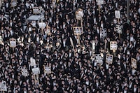 Ultra-Orthodox Jewish men protest against army recruitment, in Jerusalem, Thursday, April 11, 2024. Ultra-Orthodox men have long received exemptions from military service, which is compulsory for most Jewish men, generating widespread resentment. The Supreme Court has ordered the government to present a new proposal to force more religious men to enlist. (AP Photo/Ohad Zwigenberg)