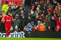 Liverpool's Mohamed Salah celebrates after scoring his side's opening goal during the English Premier League soccer match between Liverpool and Newcastle, at Anfield stadium in Liverpool, England, Monday, Jan. 1, 2024. (AP Photo/Jon Super)
